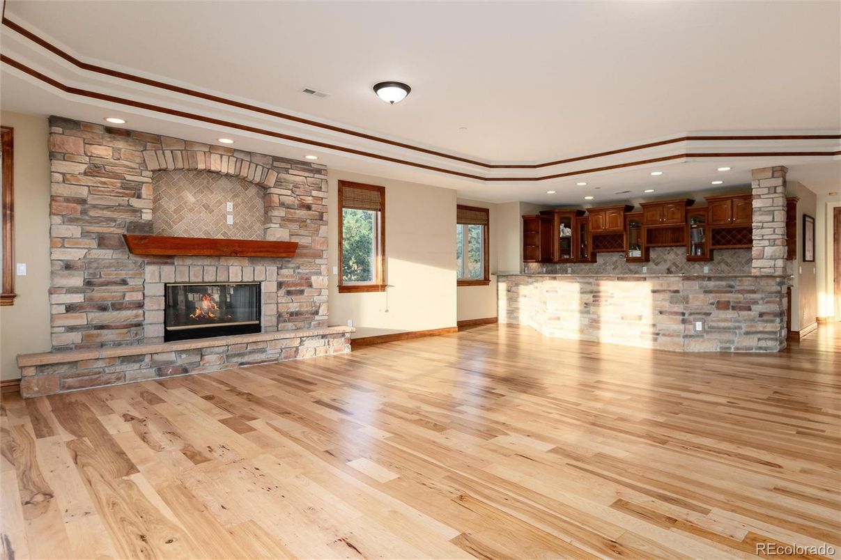 Empty room, Fireplace, Interior, Recessed Lighting, Stone Walls, Wood Texture Flooring