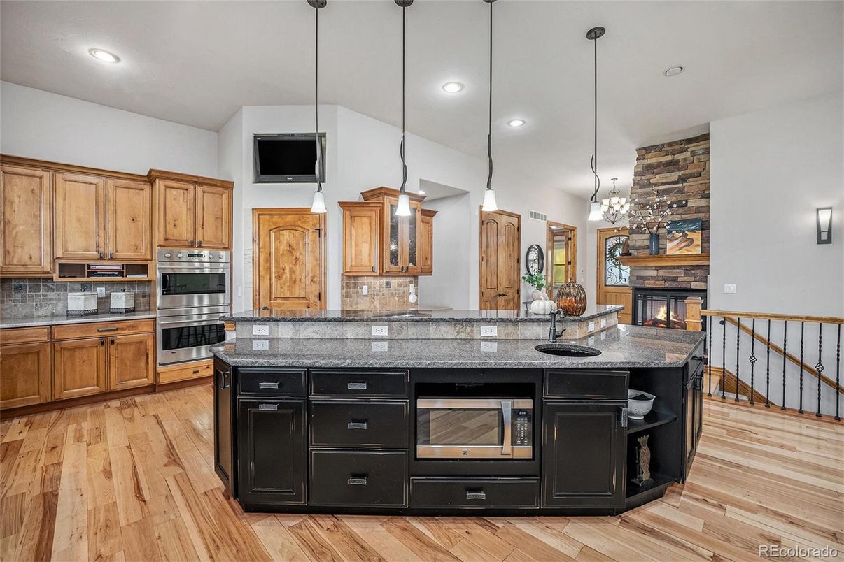 Fireplace, Interior, Kitchen, Pendant Lights, Recessed Lighting, Stainless Steel Appliances, Wood Texture Flooring