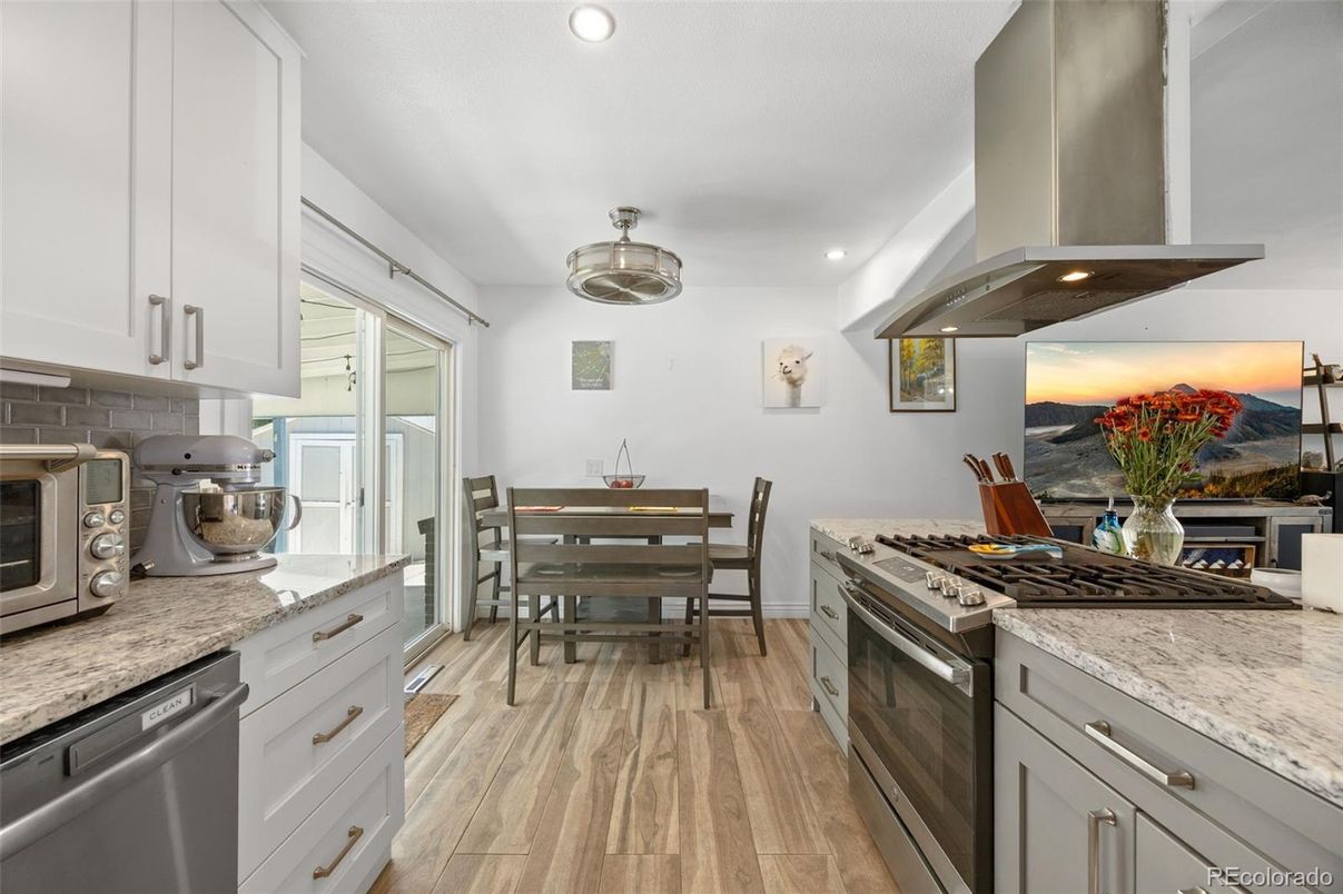 Dining room, Interior, Kitchen, Recessed Lighting, Stainless Steel Appliances, Wood Texture Flooring