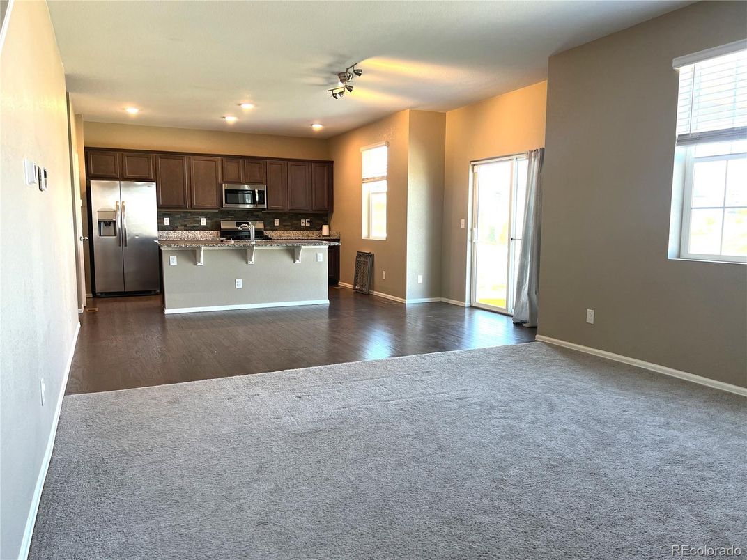Empty room, Interior, Kitchen, Recessed Lighting, Stainless Steel Appliances, Wood Texture Flooring