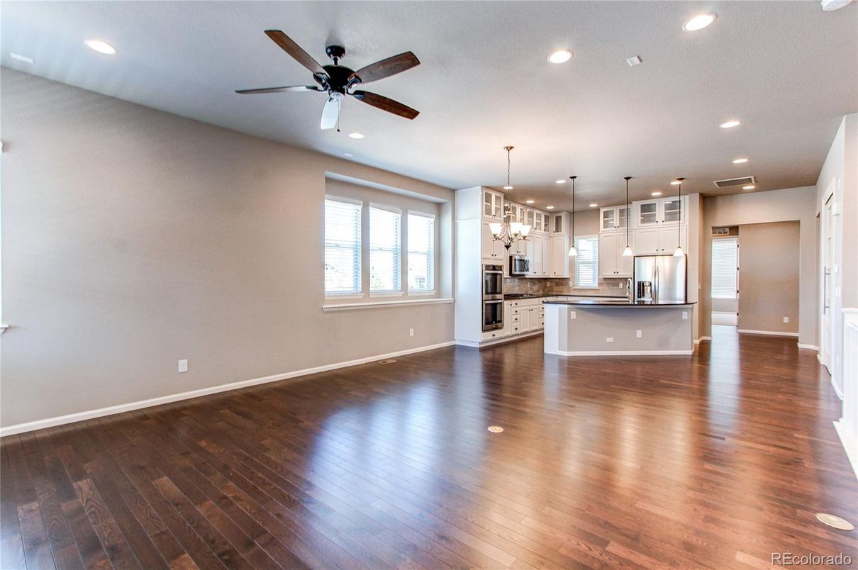 Empty room, Interior, Kitchen, Pendant Lights, Recessed Lighting, Stainless Steel Appliances, Wood Texture Flooring