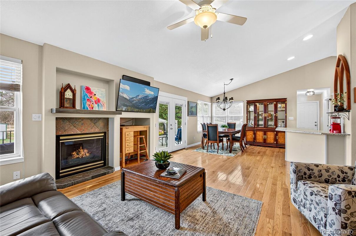 Chandelier, Dining room, Fireplace, Interior, Living room, Pendant Lights, Recessed Lighting, Wood Texture Flooring