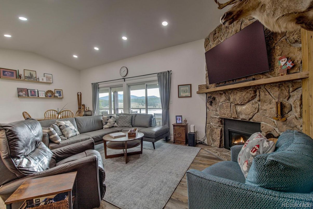 Fireplace, Interior, Living room, Recessed Lighting, Stone Walls, Wood Texture Flooring