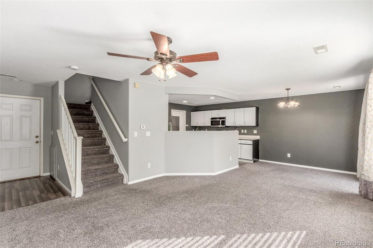Empty room, Interior, Kitchen, Pendant Lights, Recessed Lighting, Stainless Steel Appliances, Wood Texture Flooring