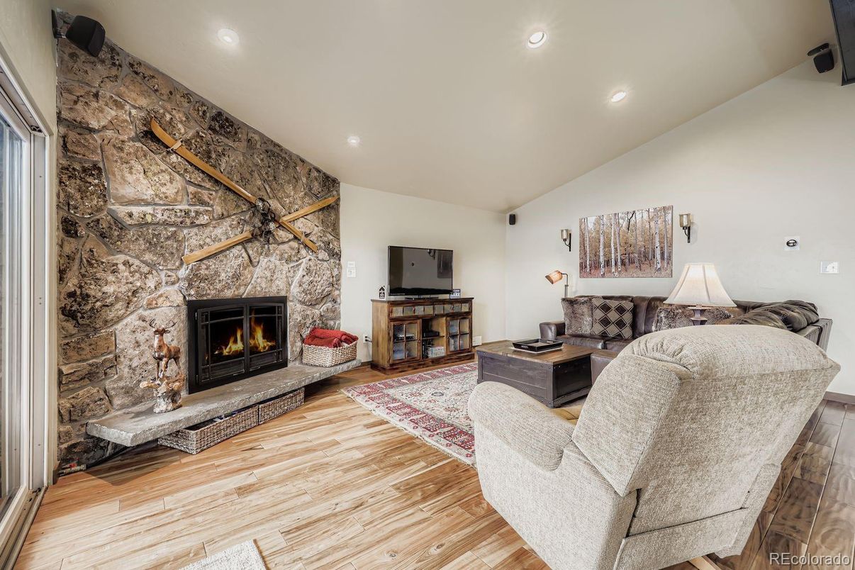 Fireplace, Interior, Living room, Recessed Lighting, Stone Walls, Wood Texture Flooring