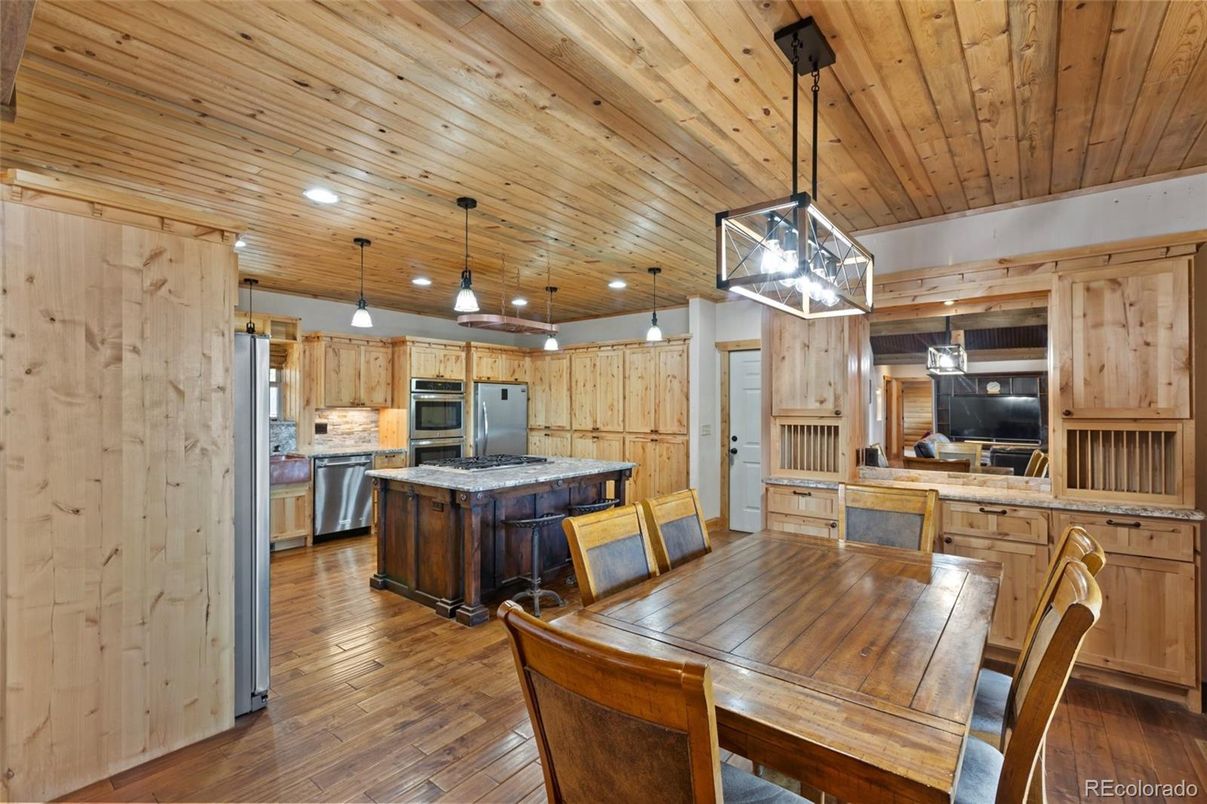 Dining room, Interior, Kitchen, Pendant Lights, Recessed Lighting, Stainless Steel Appliances, Wooden Ceilings, Wood Texture Flooring, Wooden Walls