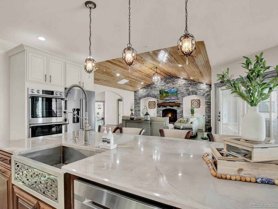 Fireplace, Interior, Kitchen, Living room, Pendant Lights, Recessed Lighting, Stainless Steel Appliances, Stone Walls, Wooden Ceilings