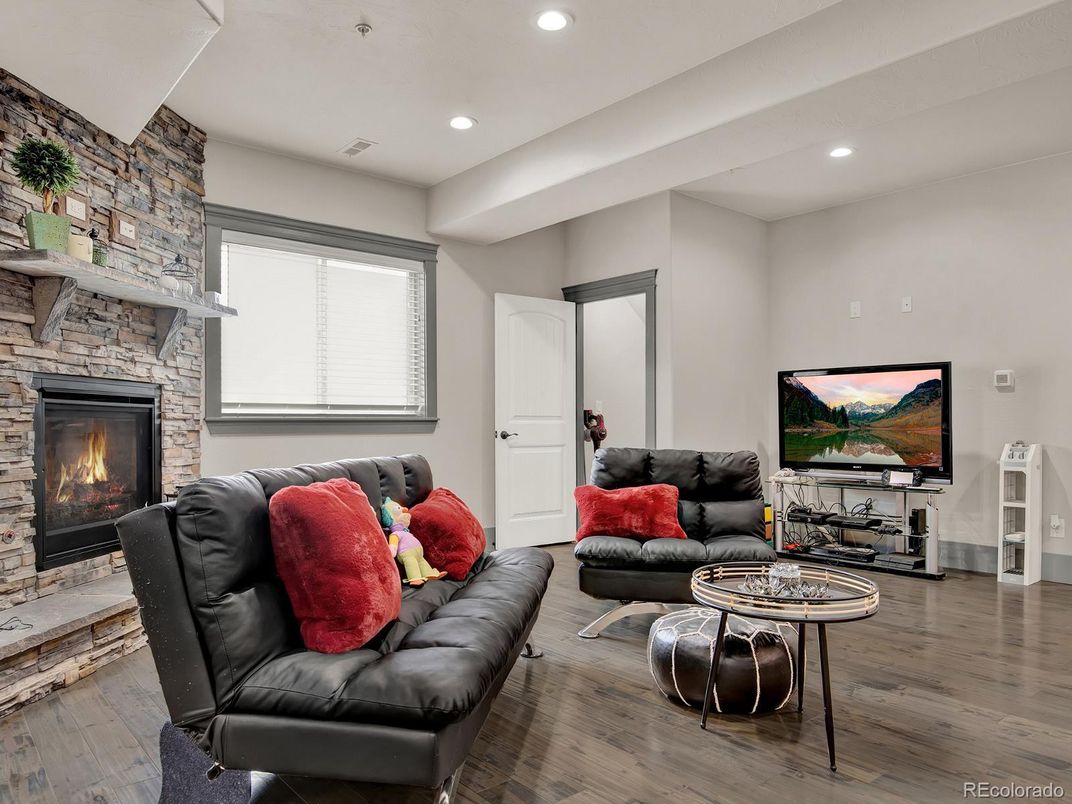 Fireplace, Interior, Living room, Recessed Lighting, Stone Walls, Wood Texture Flooring