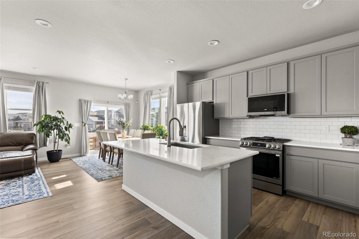 Chandelier, Dining room, Interior, Kitchen, Recessed Lighting, Stainless Steel Appliances, Wood Texture Flooring
