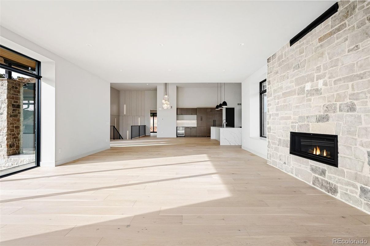 Empty room, Fireplace, Interior, Kitchen, Pendant Lights, Recessed Lighting, Stone Walls, Wood Texture Flooring