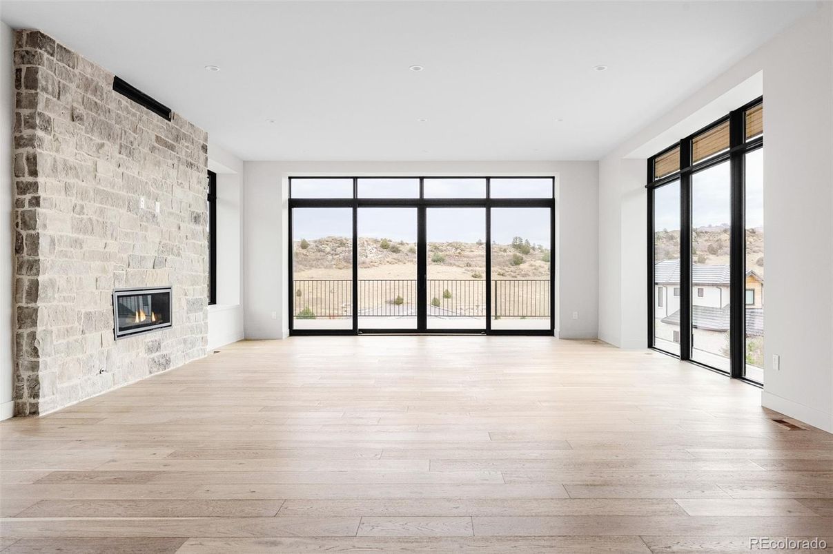 Empty room, Fireplace, Interior, Recessed Lighting, Stone Walls, Wood Texture Flooring