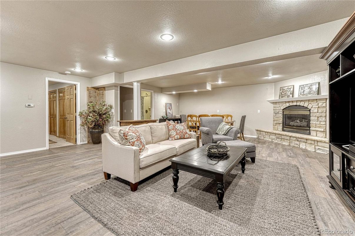 Fireplace, Interior, Living room, Recessed Lighting, Stone Walls, Wood Texture Flooring