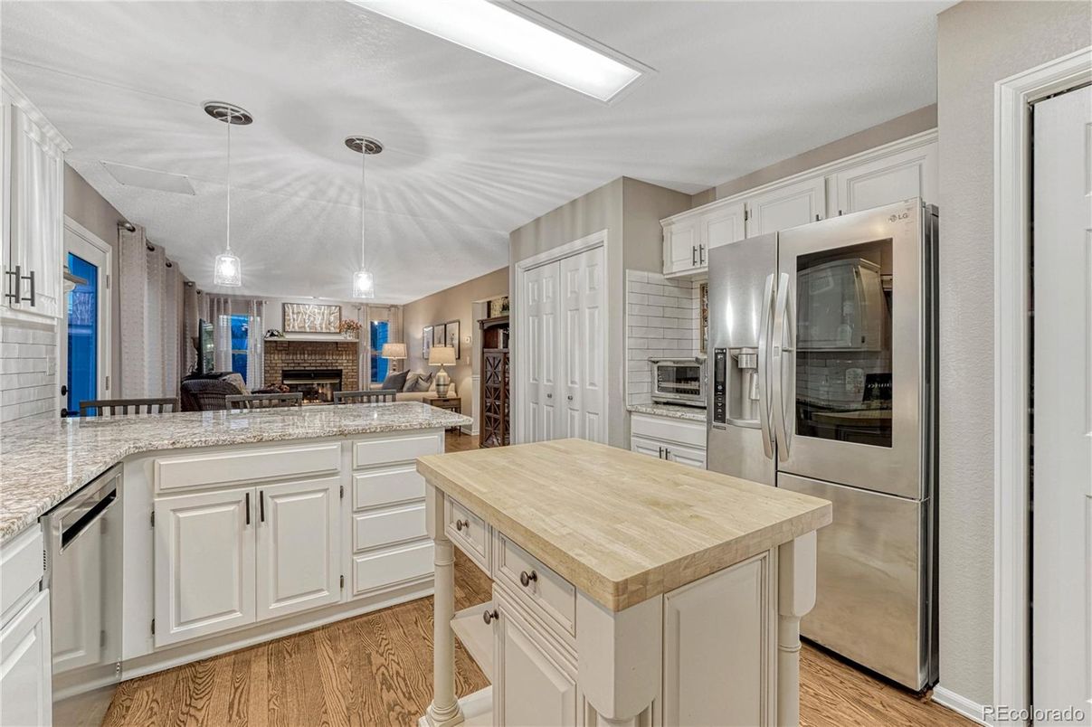 Fireplace, Interior, Kitchen, Pendant Lights, Recessed Lighting, Stainless Steel Appliances, Wood Texture Flooring