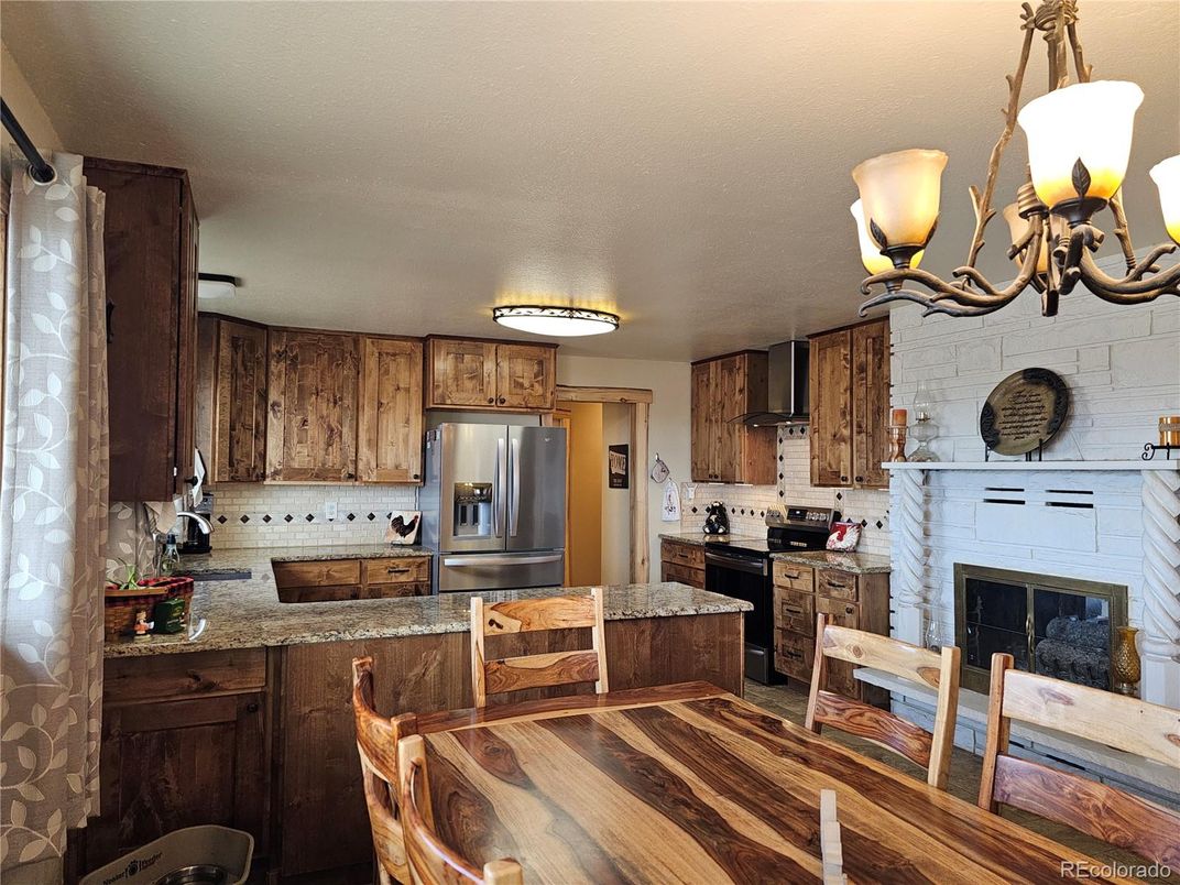 Chandelier, Dining room, Fireplace, Interior, Kitchen, Stainless Steel Appliances, Stone Walls