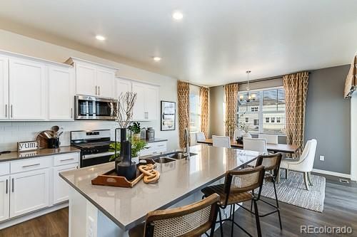 Chandelier, Dining room, Interior, Kitchen, Recessed Lighting, Stainless Steel Appliances, Wood Texture Flooring
