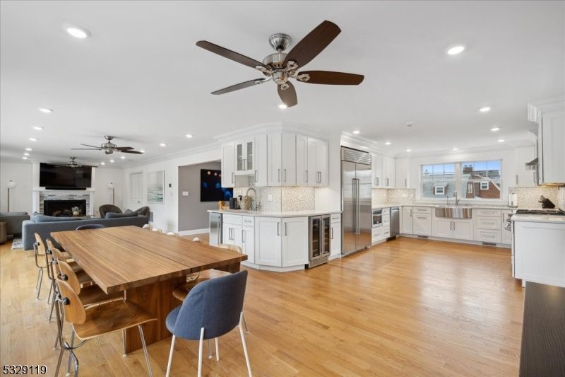 Dining room, Fireplace, Interior, Kitchen, Living room, Recessed Lighting, Stainless Steel Appliances, Wood Texture Flooring
