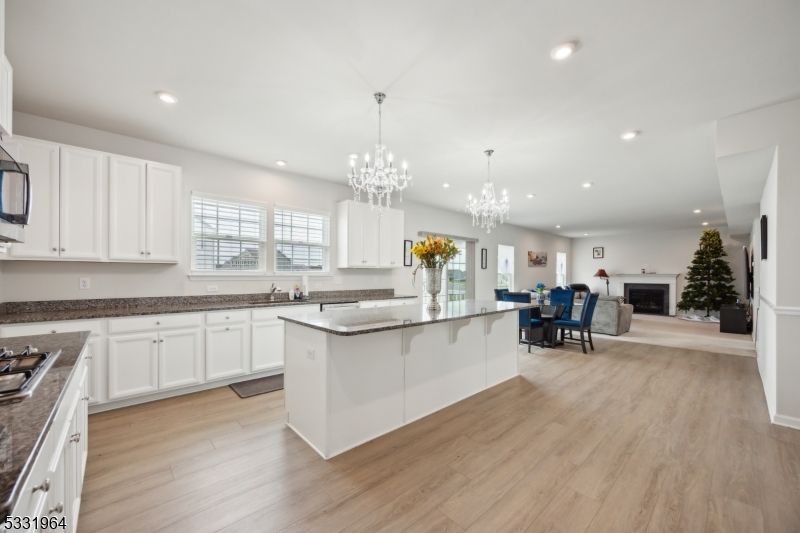 Chandelier, Dining room, Fireplace, Interior, Kitchen, Recessed Lighting, Wood Texture Flooring