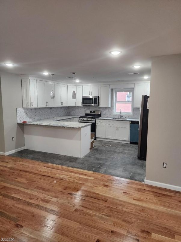 Interior, Kitchen, Marble Walls, Recessed Lighting, Stainless Steel Appliances, Wood Texture Flooring
