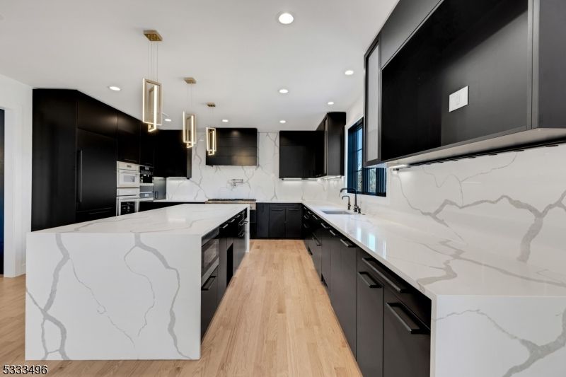 Interior, Kitchen, Marble Walls, Pendant Lights, Recessed Lighting, Stainless Steel Appliances, Wood Texture Flooring
