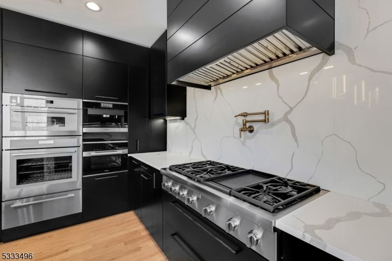 Interior, Kitchen, Marble Walls, Recessed Lighting, Stainless Steel Appliances, Wood Texture Flooring