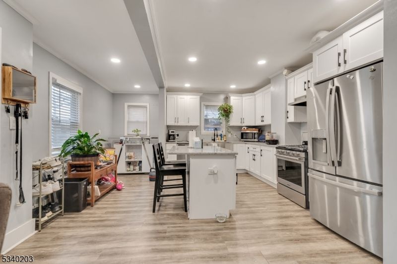Dining room, Interior, Kitchen, Recessed Lighting, Stainless Steel Appliances, Wood Texture Flooring