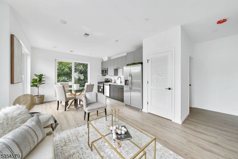 Dining room, Interior, Kitchen, Living room, Recessed Lighting, Stainless Steel Appliances, Wood Texture Flooring