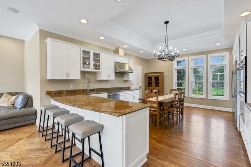Chandelier, Dining room, Interior, Kitchen, Pendant Lights, Recessed Lighting, Stainless Steel Appliances, Wood Texture Flooring