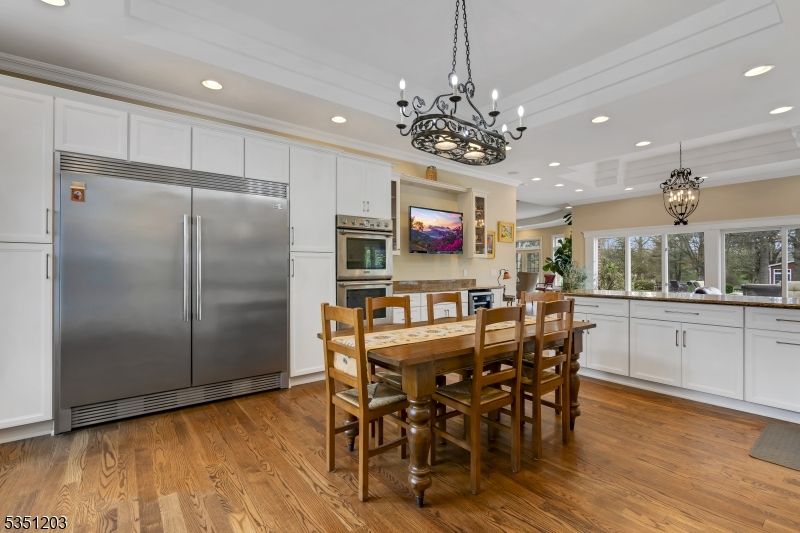 Chandelier, Dining room, Interior, Kitchen, Pendant Lights, Recessed Lighting, Stainless Steel Appliances, Wood Texture Flooring