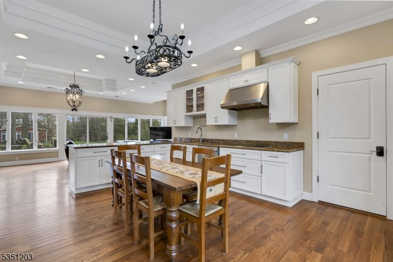 Chandelier, Dining room, Interior, Kitchen, Pendant Lights, Recessed Lighting, Stainless Steel Appliances, Wood Texture Flooring