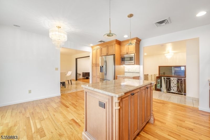 Chandelier, Dining room, Interior, Kitchen, Pendant Lights, Recessed Lighting, Stainless Steel Appliances, Wood Texture Flooring