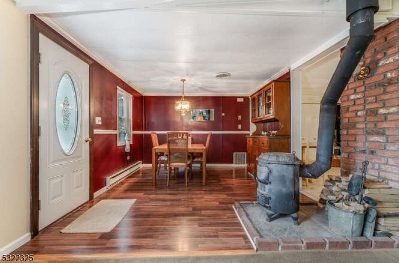 Chandelier, Dining room, Fireplace, Interior, Pendant Lights, Stone Walls, Wood Texture Flooring
