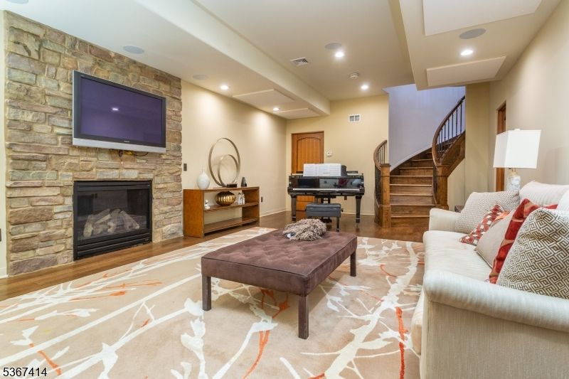 Fireplace, Interior, Living room, Piano, Recessed Lighting, Stone Walls, Wood Texture Flooring