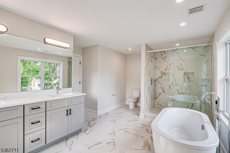 Bathroom, Dual Sink Vanities, Free Standing Baths, Glass Shower, Interior, Marble, Marble Walls, Recessed Lighting