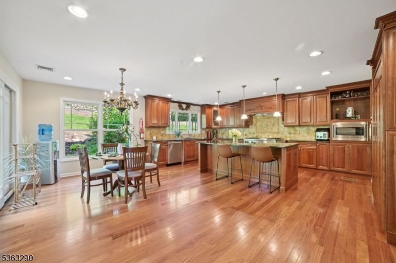 Chandelier, Dining room, Interior, Kitchen, Pendant Lights, Recessed Lighting, Stainless Steel Appliances, Wood Texture Flooring