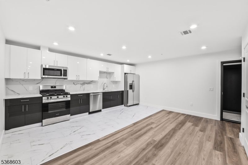 Interior, Kitchen, Marble, Marble Walls, Recessed Lighting, Stainless Steel Appliances, Wood Texture Flooring