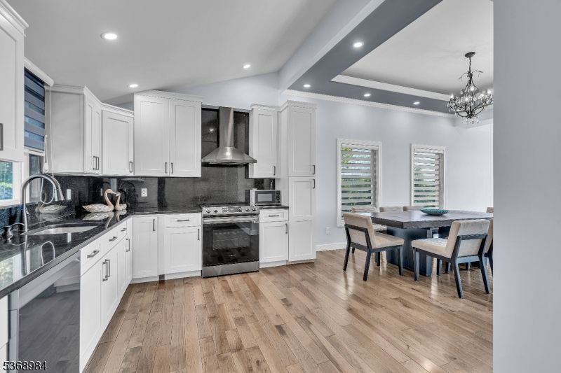 Chandelier, Dining room, Interior, Kitchen, Recessed Lighting, Stainless Steel Appliances, Wood Texture Flooring