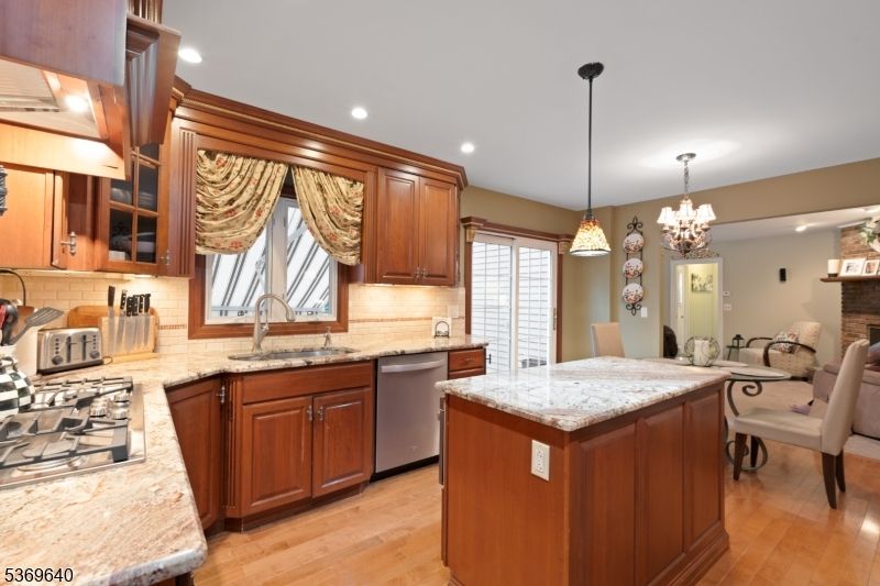 Chandelier, Dining room, Interior, Kitchen, Pendant Lights, Recessed Lighting, Stainless Steel Appliances, Wood Texture Flooring