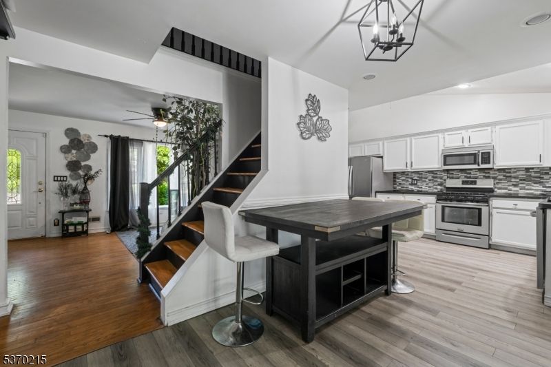 Dining room, Interior, Kitchen, Pendant Lights, Recessed Lighting, Stainless Steel Appliances, Wood Texture Flooring
