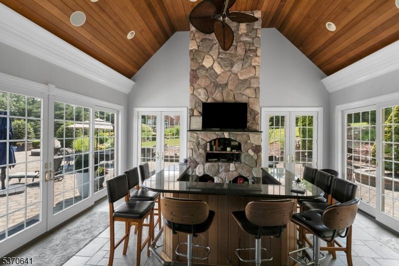 Dining room, Fireplace, Interior, Recessed Lighting, Stone Walls, Wooden Ceilings