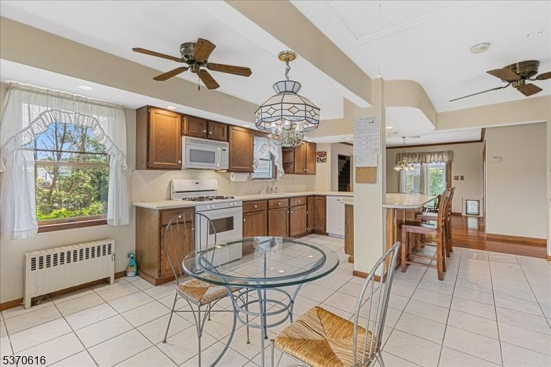 Chandelier, Dining room, Interior, Kitchen, Pendant Lights, Recessed Lighting, Stainless Steel Appliances, Wood Texture Flooring