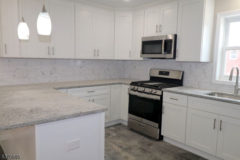 Interior, Kitchen, Marble Walls, Pendant Lights, Recessed Lighting, Stainless Steel Appliances