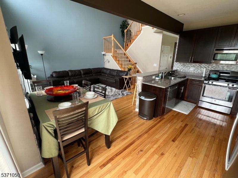 Dining room, Interior, Kitchen, Living room, Recessed Lighting, Stainless Steel Appliances, Wood Texture Flooring