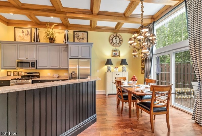 Chandelier, Dining room, Interior, Kitchen, Recessed Lighting, Stainless Steel Appliances, Wooden Beams, Wood Texture Flooring