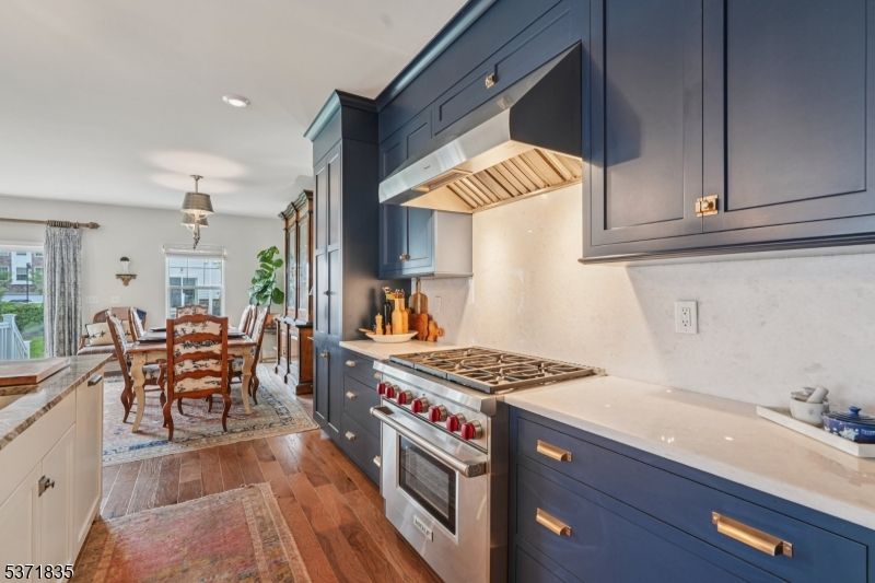 Chandelier, Dining room, Fireplace, Interior, Kitchen, Pendant Lights, Recessed Lighting, Stainless Steel Appliances, Wood Texture Flooring