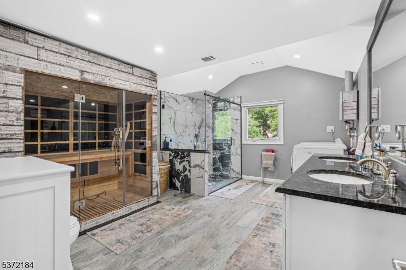 Bathroom, Dual Sink Vanities, Glass Shower, Interior, Marble Walls, Recessed Lighting, Walk-in Closets, Wood Texture Flooring