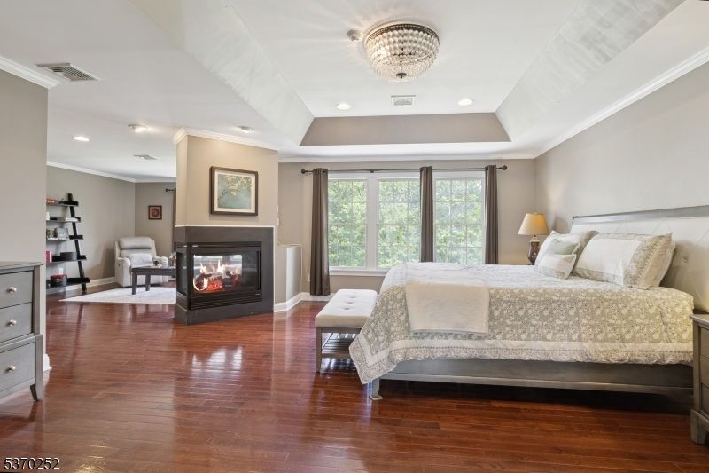 Bedroom, Chandelier, Fireplace, Interior, Recessed Lighting, Wood Texture Flooring