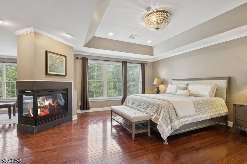 Bedroom, Chandelier, Fireplace, Interior, Recessed Lighting, Wood Texture Flooring