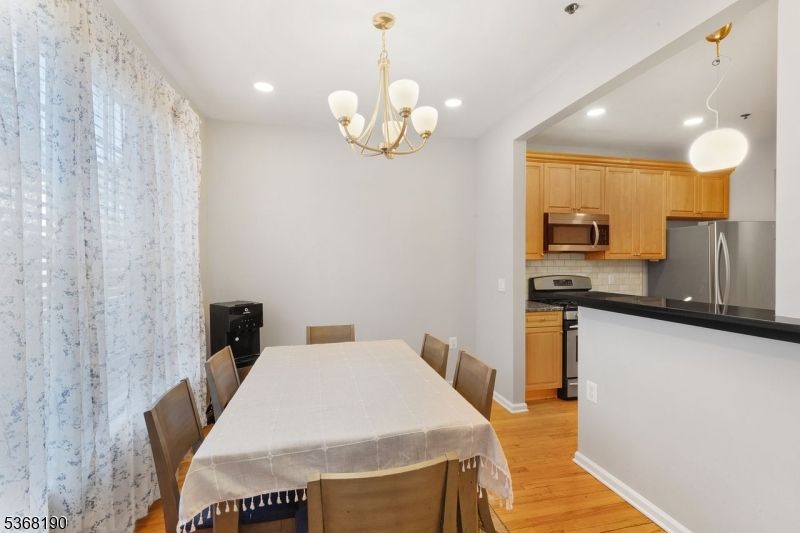 Chandelier, Dining room, Interior, Kitchen, Pendant Lights, Recessed Lighting, Stainless Steel Appliances, Wood Texture Flooring