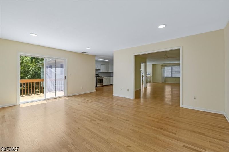 Empty room, Interior, Kitchen, Recessed Lighting, Stainless Steel Appliances, Wood Texture Flooring