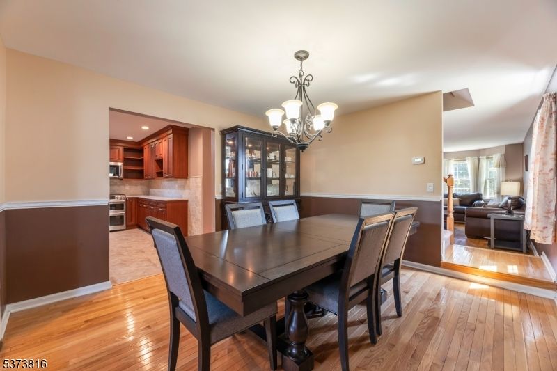 Chandelier, Dining room, Interior, Kitchen, Living room, Recessed Lighting, Stainless Steel Appliances, Wood Texture Flooring